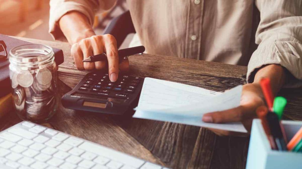 A man working to determine how fast he can pay off his loan.